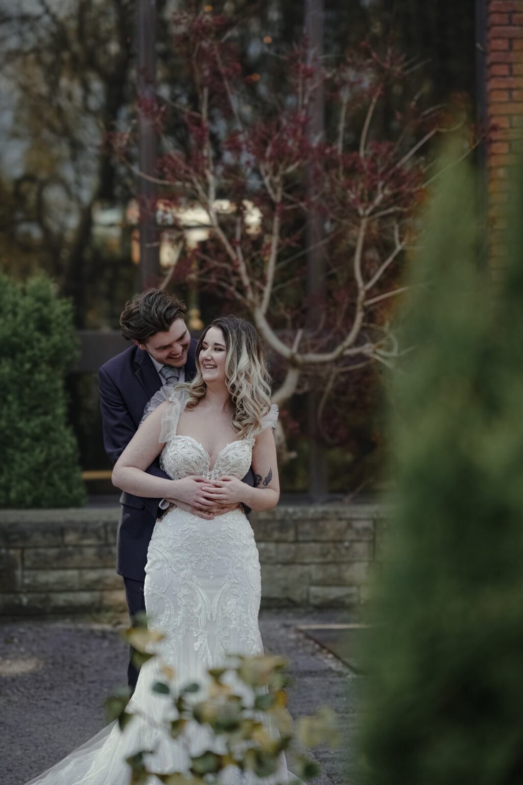 A couple in the gardens at Park Hall at dusk